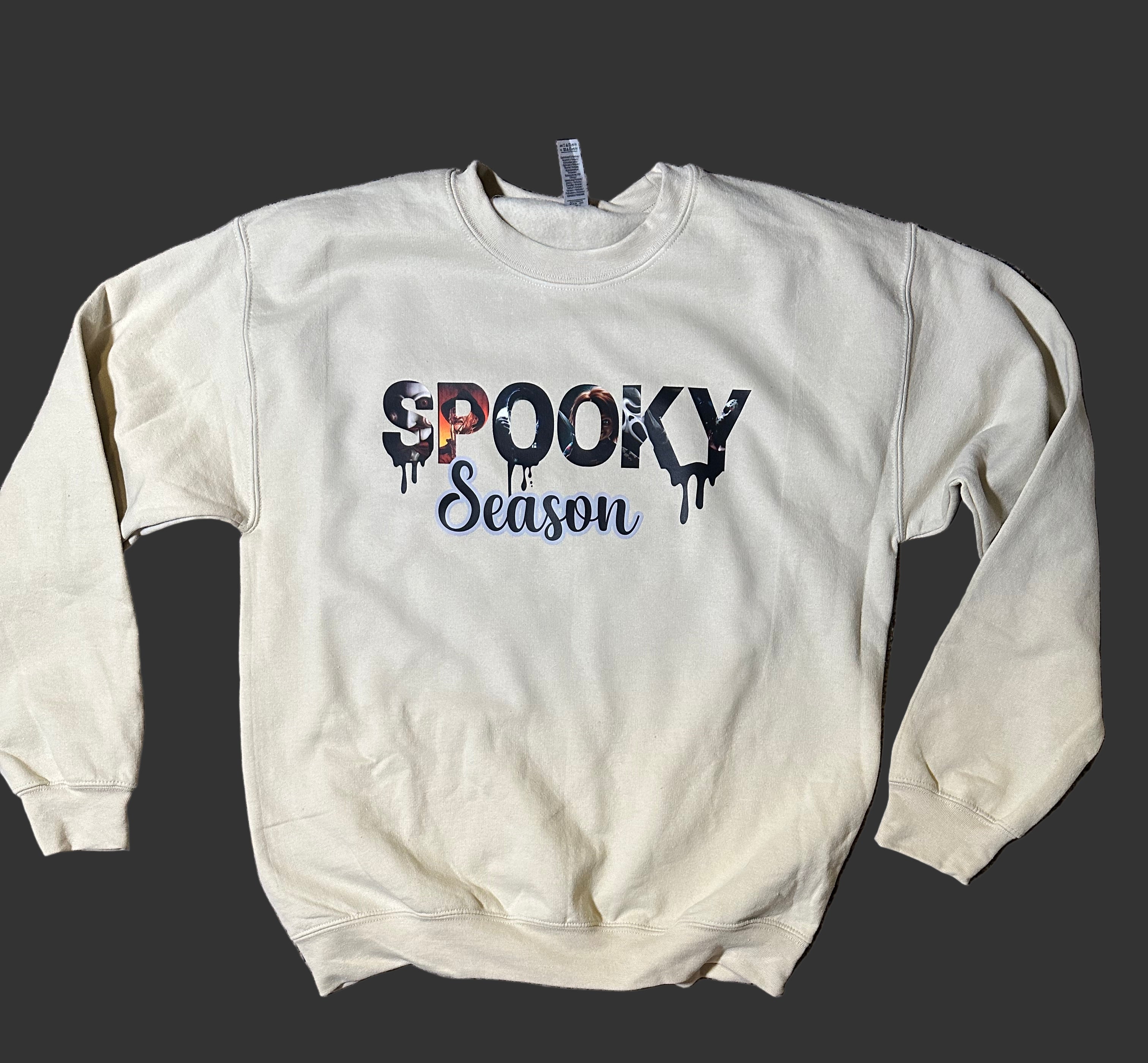 White sweatshirt with 'Spooky Season' text on a black background