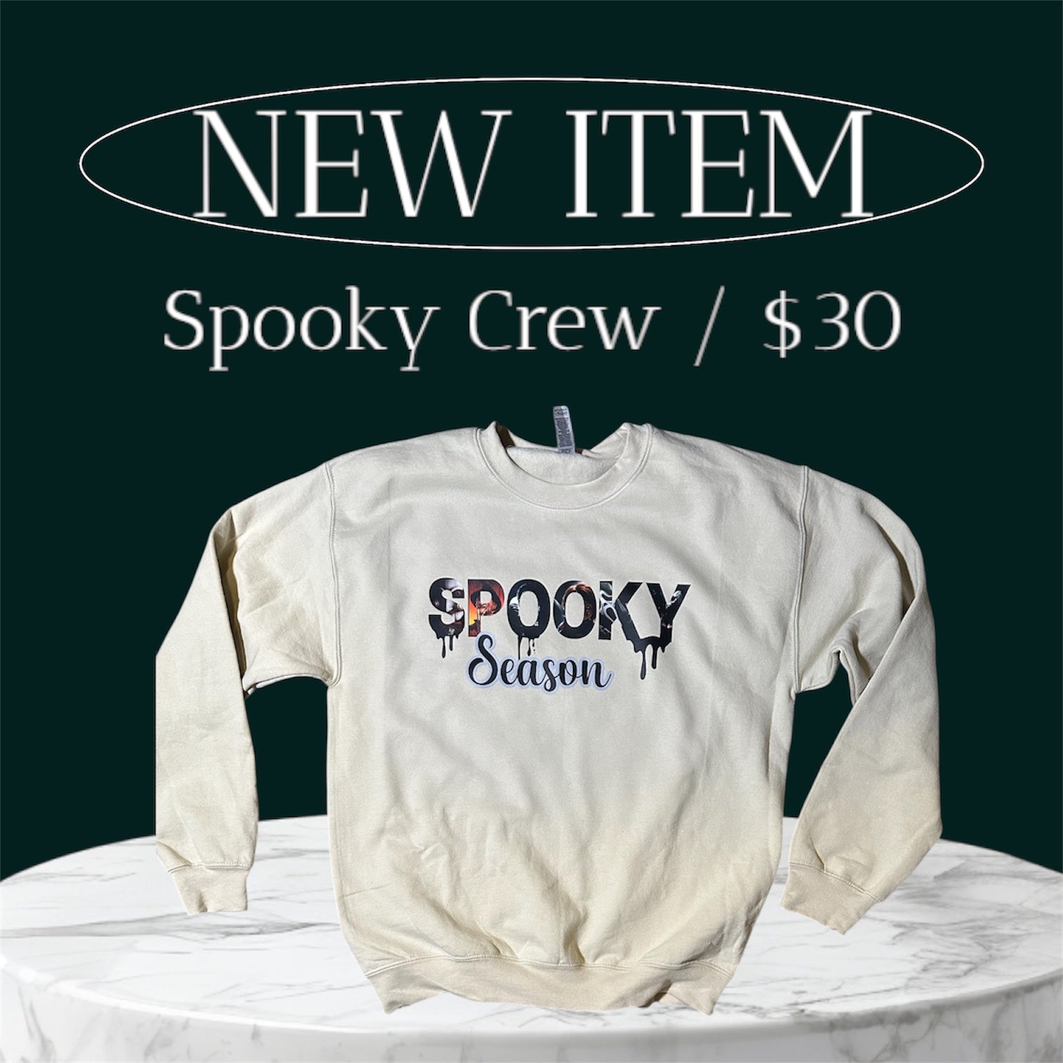White sweatshirt with 'Spooky Season' text on a green background with promotional text.